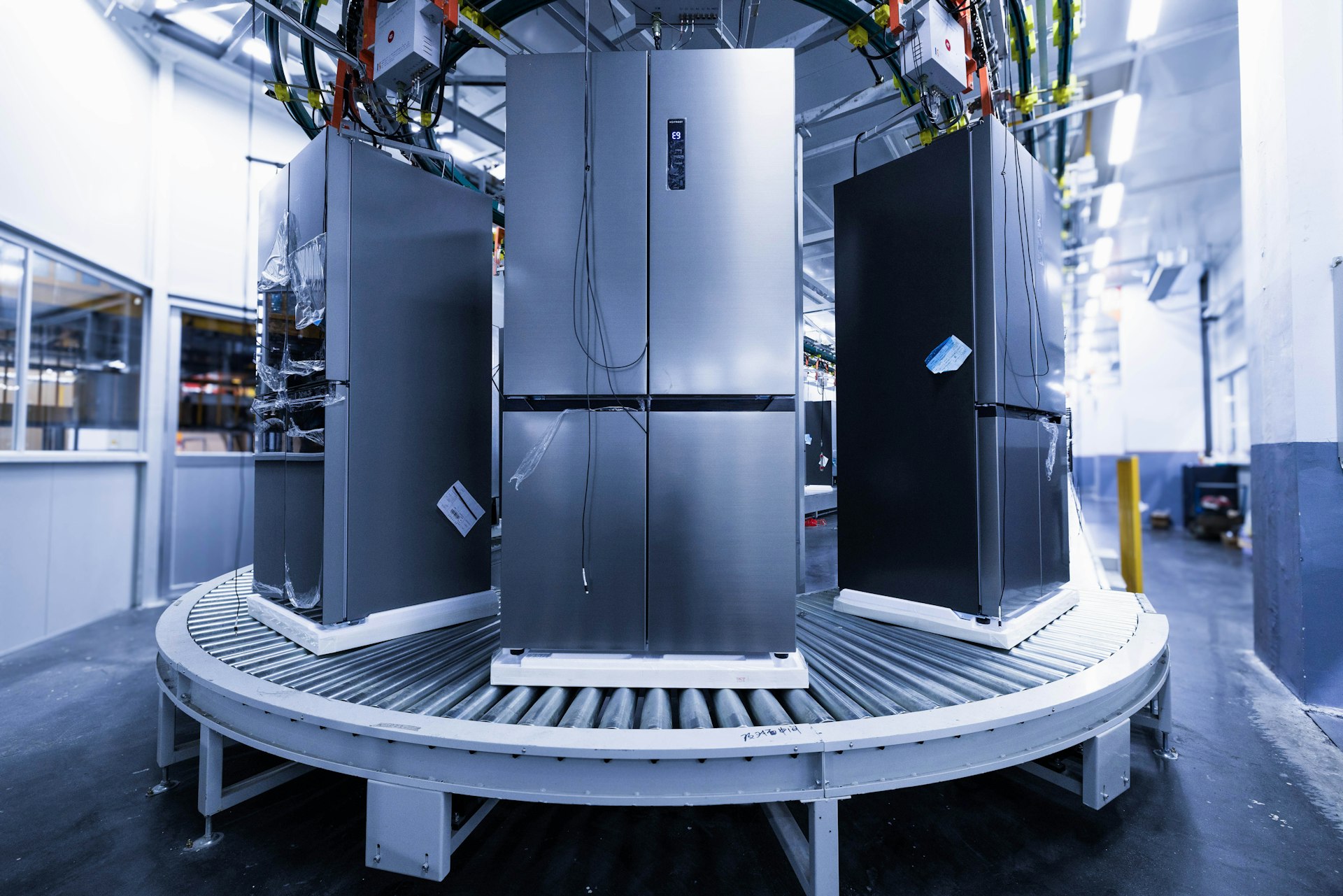 a group of refrigerators sitting inside of a building